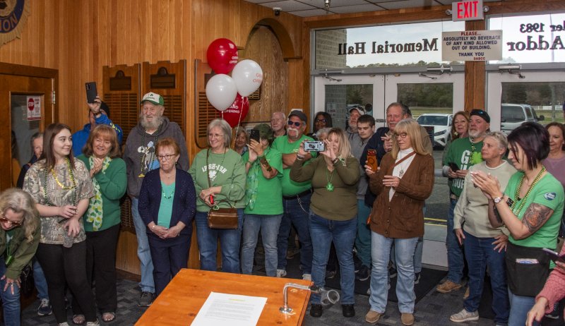 Attendees cheer the ribbon cutting of the new event space at American Legion Post 28.
